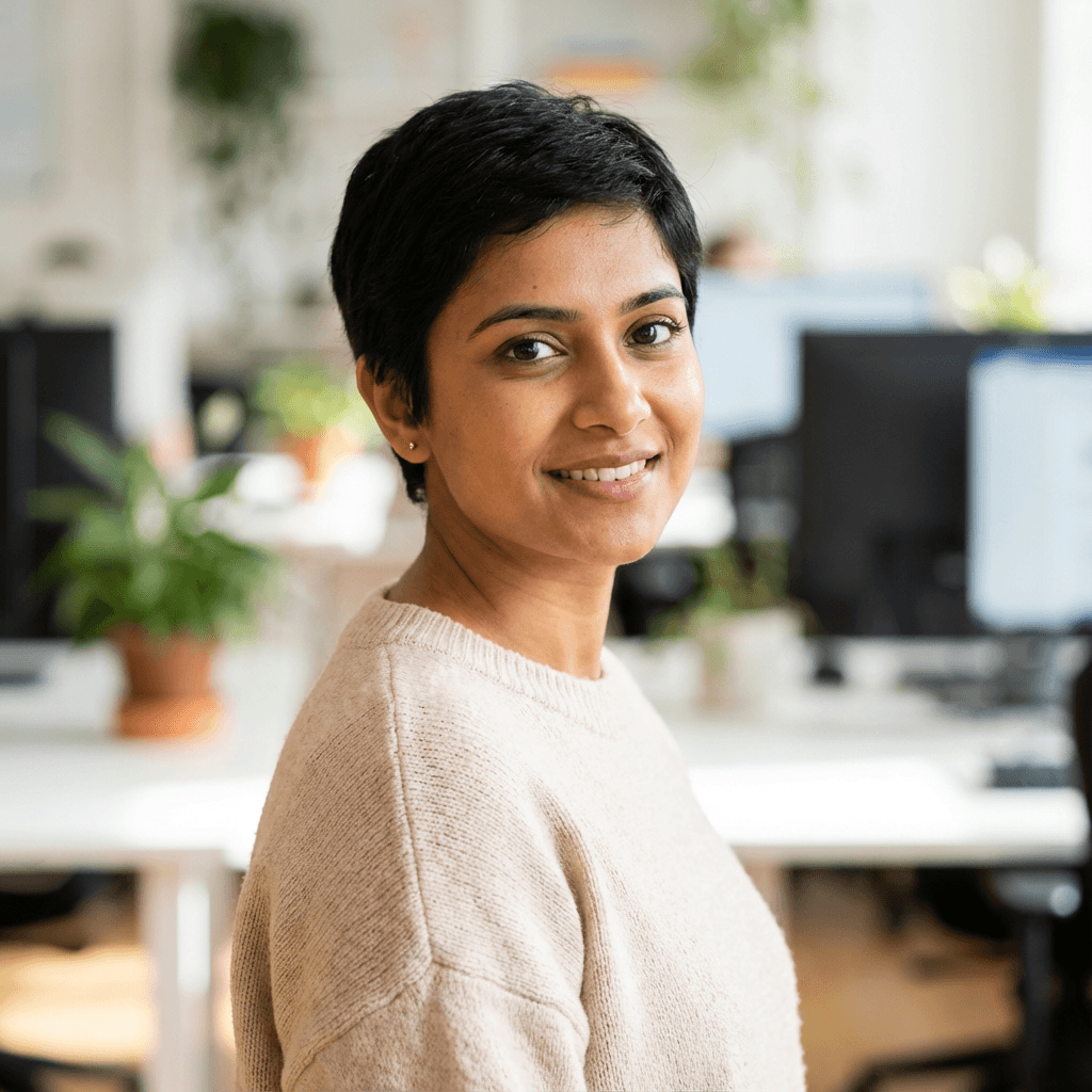 Female entrepreneur standing in a bright co-working space